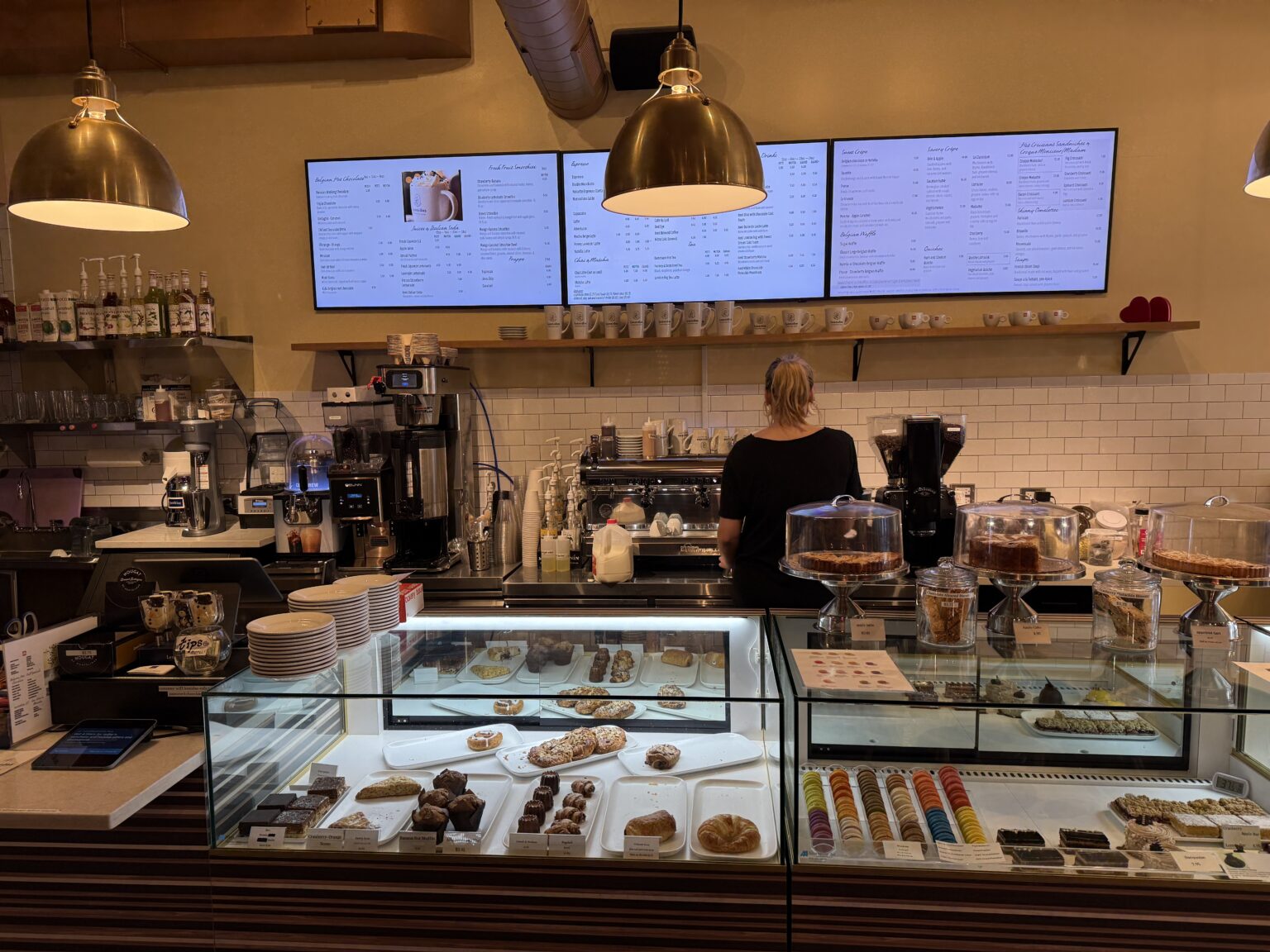 The counter at Leonidas Chocolate Cafe with chocolates and pastries on display.