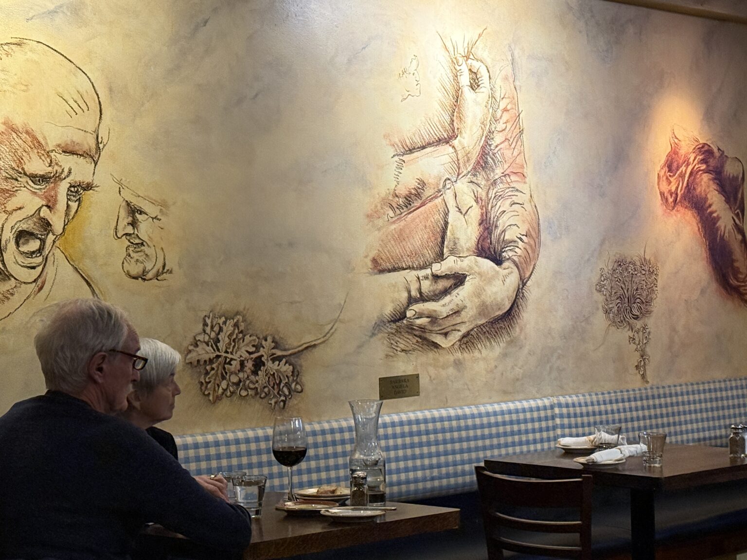The interior at Vinci Restaurant with hand-painted murals.