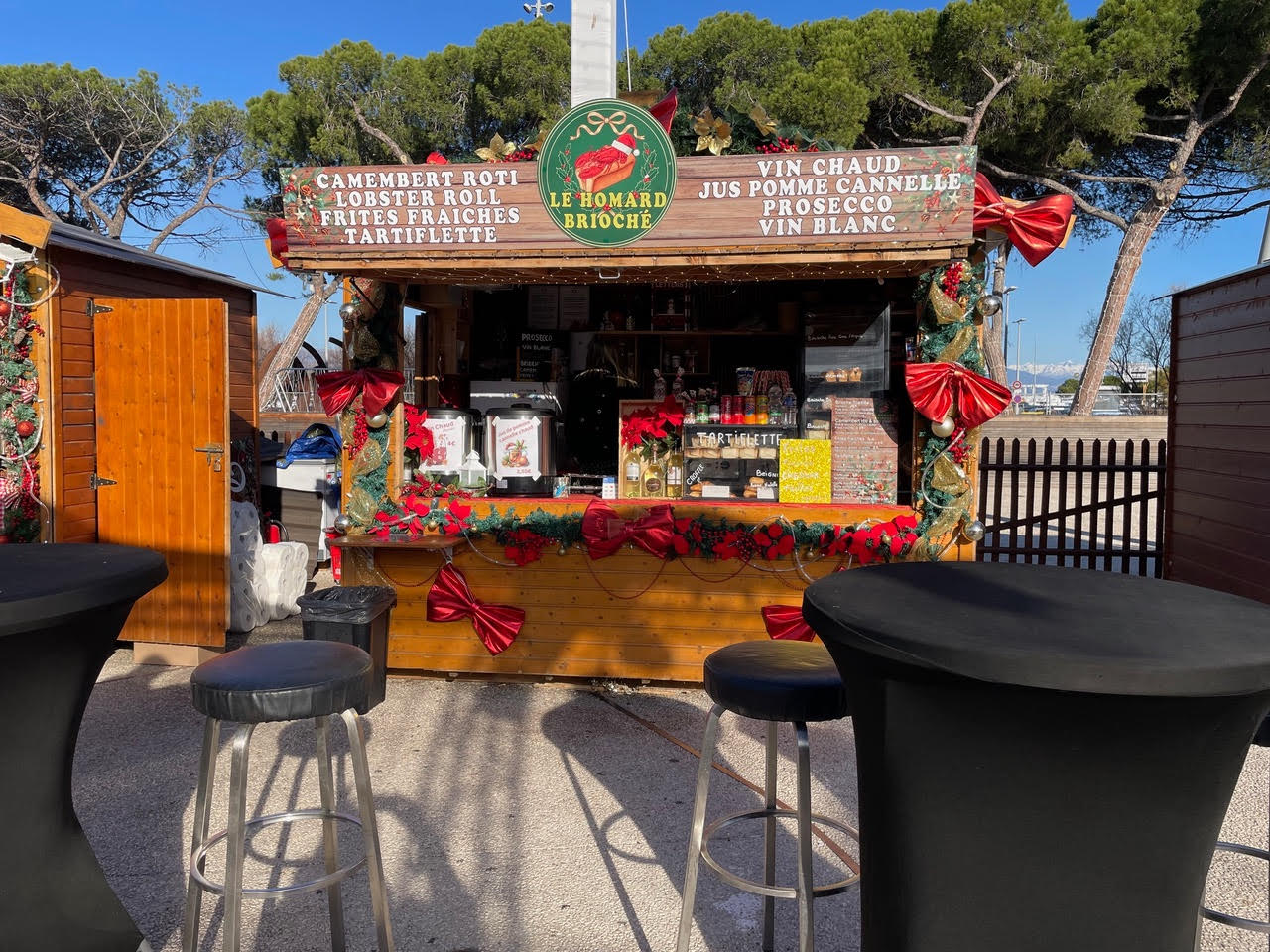 A Christmas Village food hut in Antibes offering lobster rolls, camembert roti, and vin chaud.