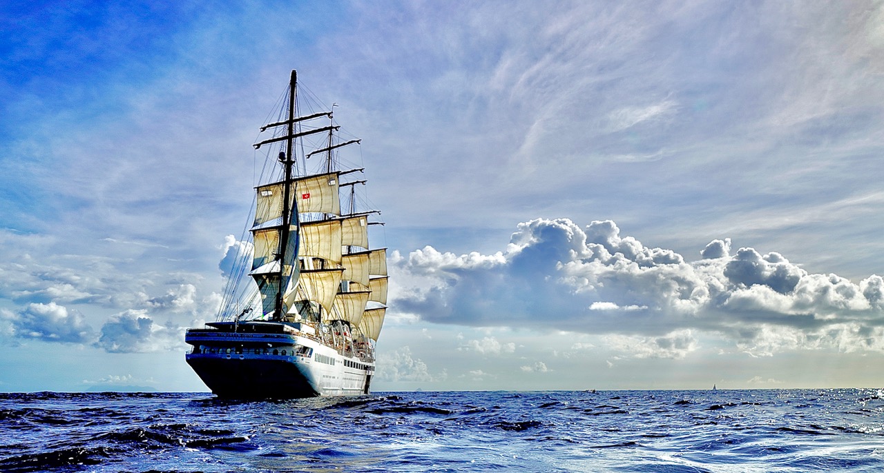 The Sea Cloud Spirit under full sail on the open ocean.