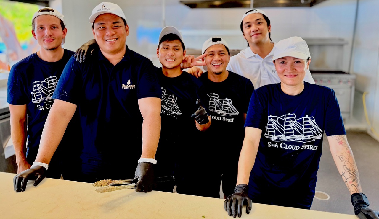 Sea Cloud Spirit kitchen staff posing in the ship's galley.