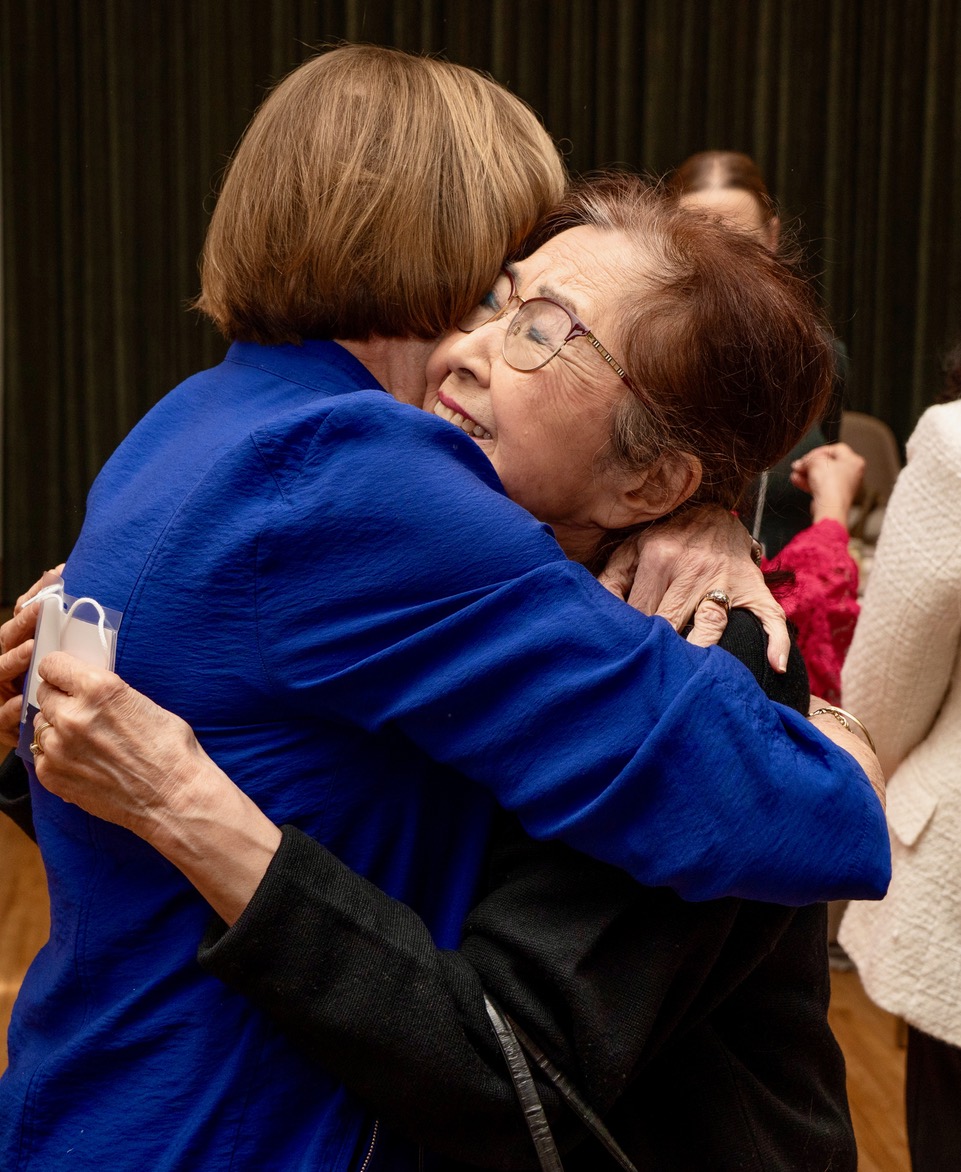 Two IWA friends embracing at the event