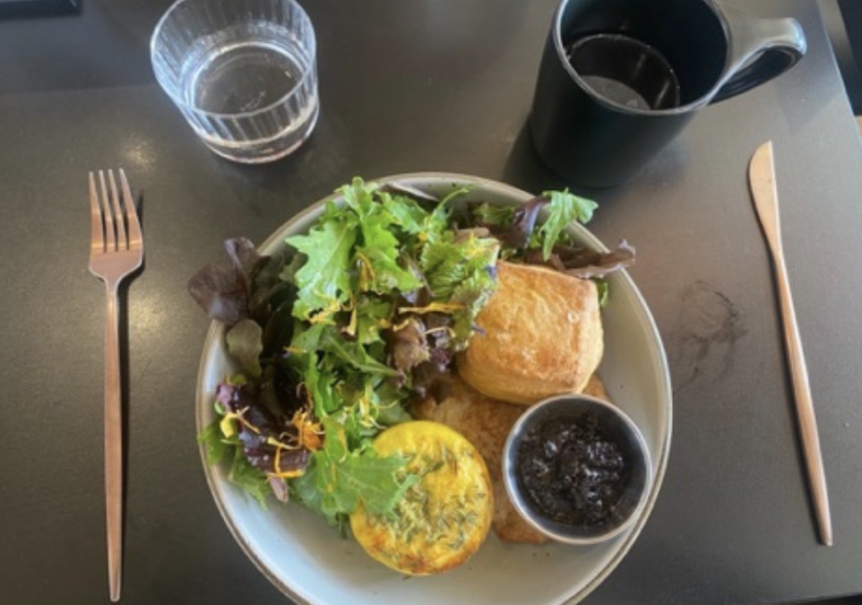 Breakfast special of eggs, chicken sausage, buttermilk biscuit, greens