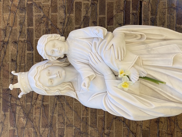 Visitors often leave a flower offering at the statue