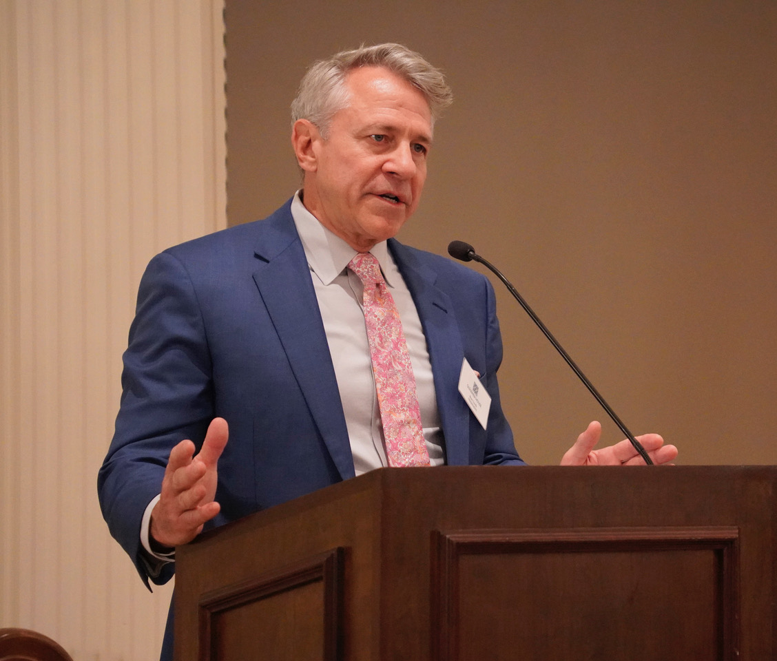 Board President Ron Loch introduces the paddle raise