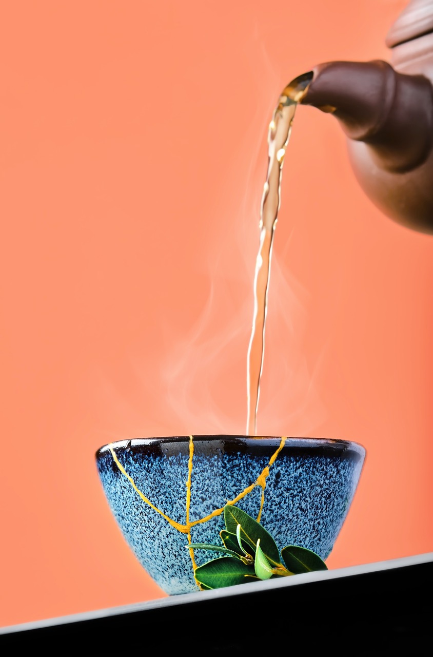 Tea pouring into a blue kintsugi bowl