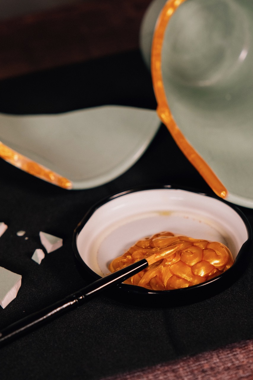 Close-up of gold lacquer being applied to broken porcelain