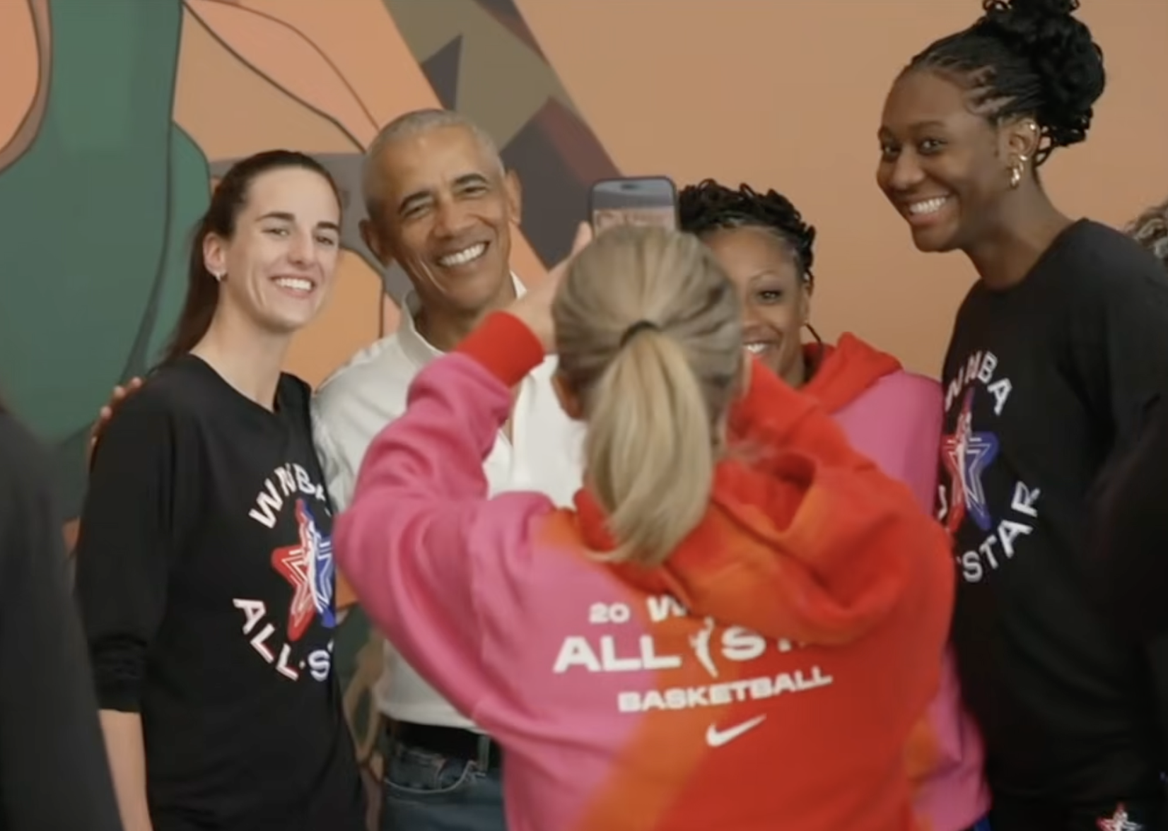 President Barack Obama and Caitlin Clark smiling for a photo