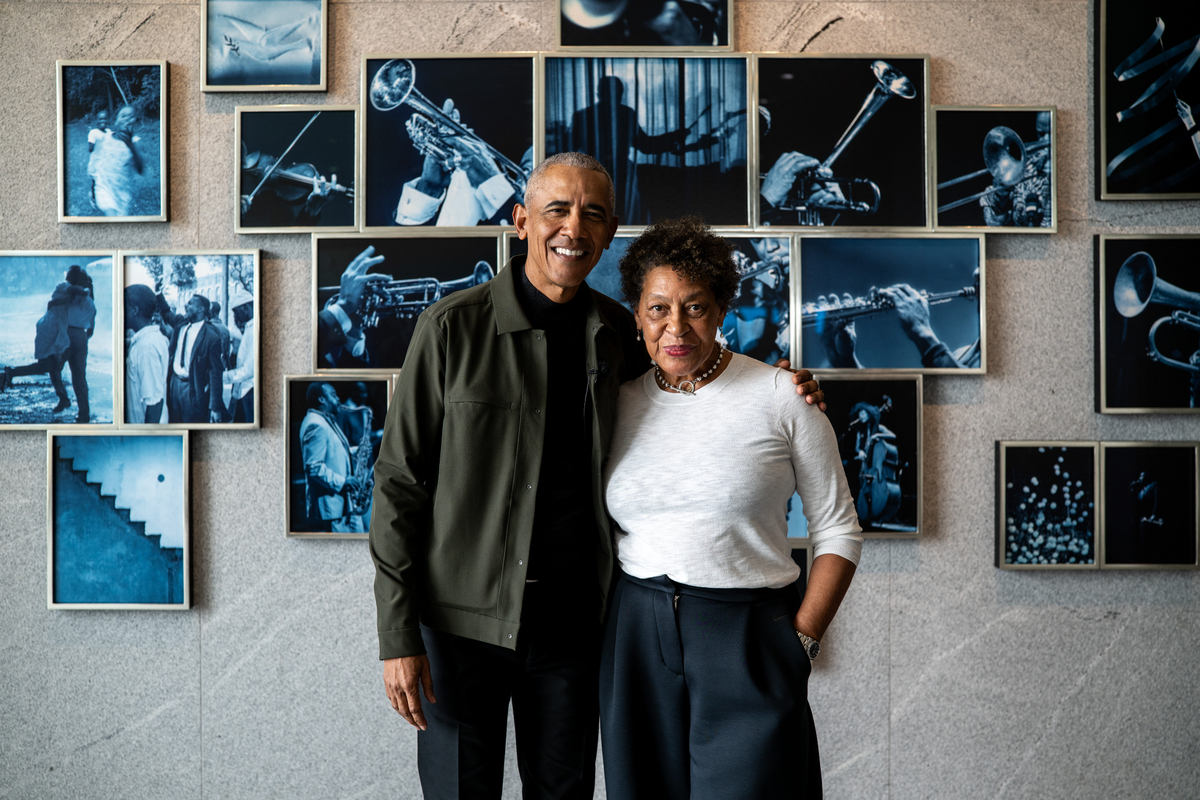 President Barack Obama and artist Carrie Mae Weems standing in front of the arti