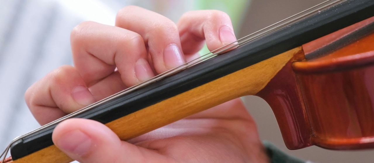 A musician's hands on a violin