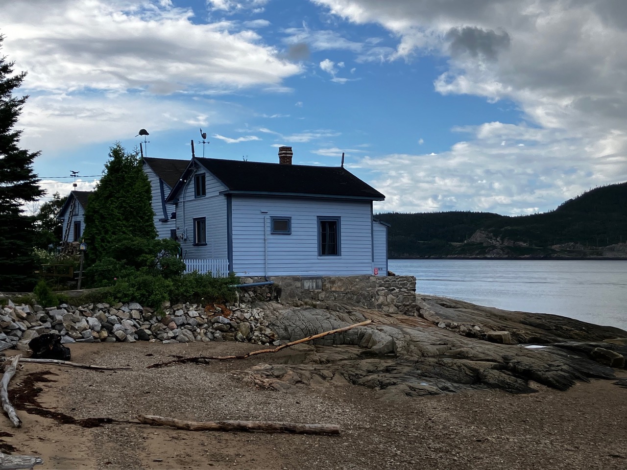 A white house on a rocky point