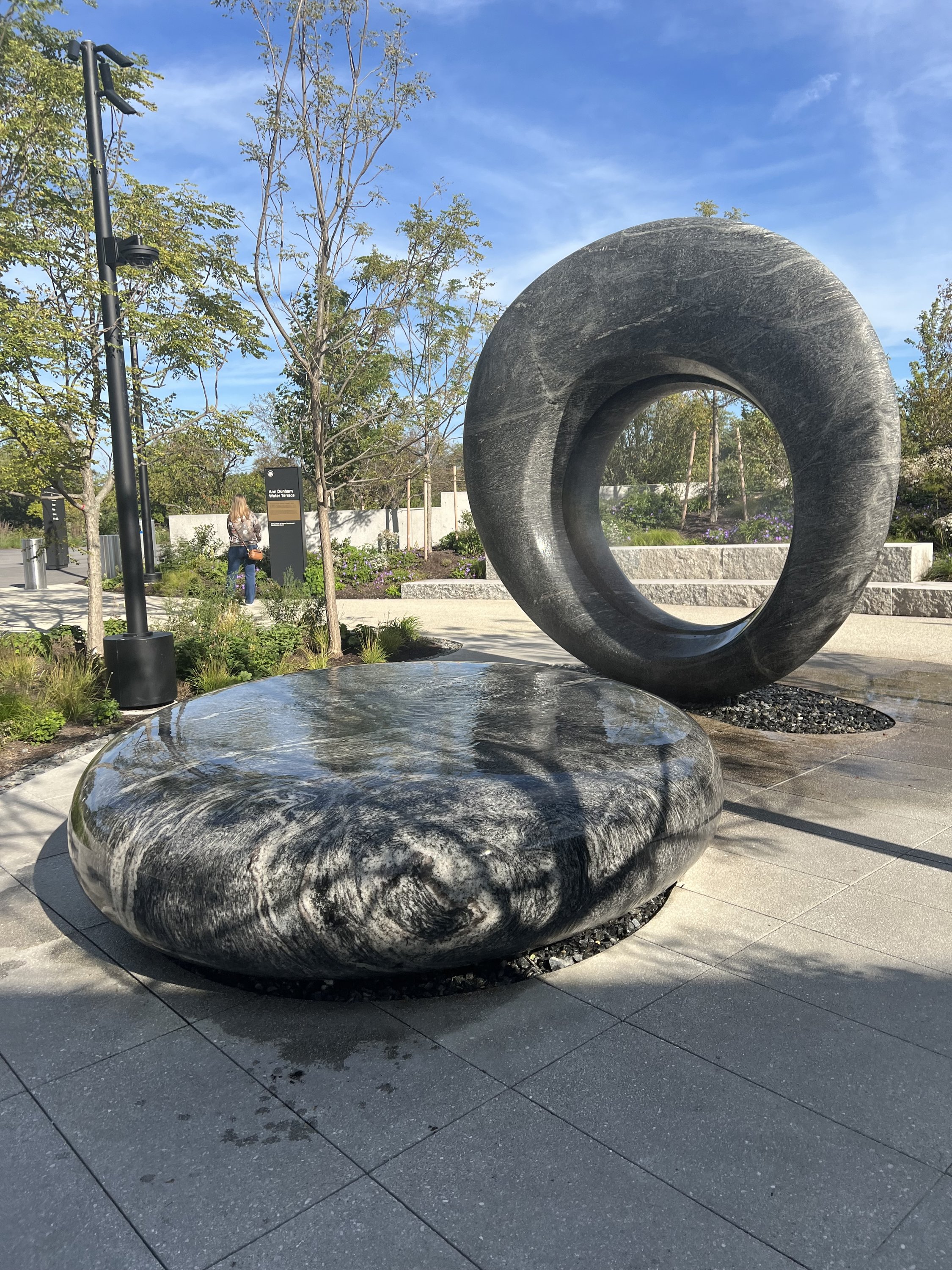A view of Maya Lin’s “Seeing Through the Universe,” sculptural water installation, two rounded granite forms, Outdoor Grounds/ Ann Dunham Water Terrace/ Obama Presidential Center. September 2026. Photo: S. Zetouni